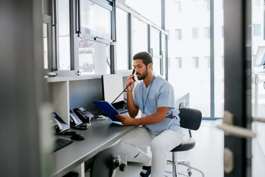 An urgent care staff member on the phone in the billing department.